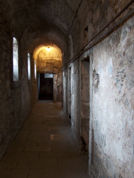 Narrow prison corridor, very cold and damp in there.
