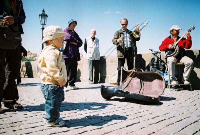 A child listening to the Bridge band.